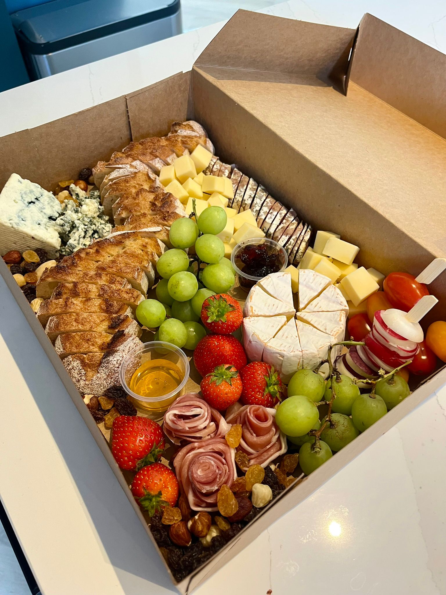 Borrelplank met kazen, vleeswaren, fruit, groenten en crackers